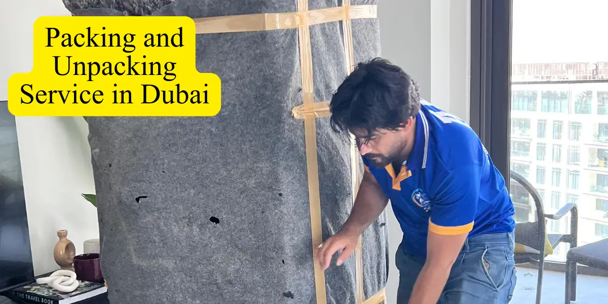 Professional packing and unpacking service in Dubai with an experienced mover carefully wrapping and protecting furniture using high-quality packing materials.